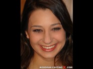 Michaella is sited on a sofa, legs appart and looking at you