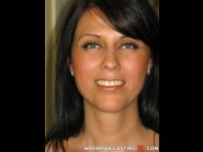 Veronika is sited on a sofa, legs appart and looking at you