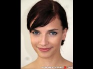 Leila smith is sited on a sofa, legs appart and looking at you