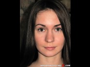 Mika is sited on a sofa, legs appart and looking at you