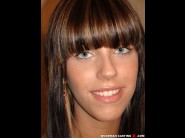 Nickol sweet is sited on a sofa, legs appart and looking at you