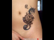 Lady mai is sited on a sofa, legs appart and looking at you