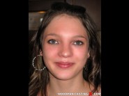 Mylena is sited on a sofa, legs appart and looking at you