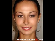 Hannah black is sited on a sofa, legs appart and looking at you