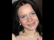 Wendy moon is sited on a sofa, legs appart and looking at you