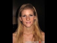 Nella bony is sited on a sofa, legs appart and looking at you